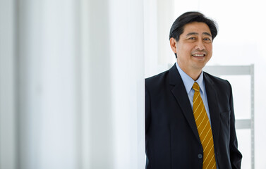 Portrait closeup shot of Asian senior happy success rich ceo corporate director in black formal...