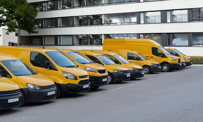 Yellow delivery vans parked in a row