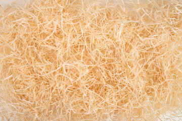 packing wood shavings chips yellow thin recycled paper box carton closeup