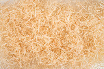 packing wood shavings chips yellow thin recycled paper box carton closeup