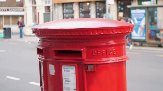 Red mailbox in London city street in 4k slow motion 60fps