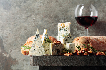 Blue cheese and red wine on an old stone table.