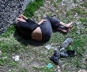 Sleeping homeless man outdoors in the city.