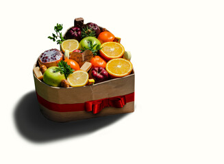 Vegetables in a heart-shaped gift box on a white background.