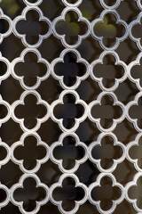 Old wrought iron grid in front of old wooden door window. Photo taken April 21st, 2021, Zurich, Switzerland.