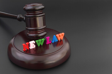 New laws concept. Words NEW LAW and judge gavel on black table, copy space for text.