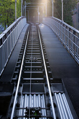 Obraz premium Tracks of cable car station at City of Zurich early in the morning at springtime. with sunbeams and backlight. Photo taken April 23rd, 2021, Zurich, Switzerland.