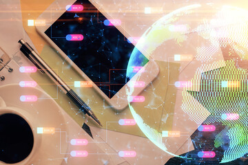 Double exposure of map hologram drawing over desktop. Top view. International connection concept.