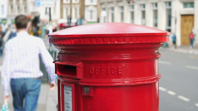 Red mailbox in London city street in 4k slow motion 60fps