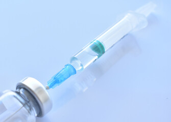 Vaccine against covid-19 and a syringe with a vaccine. Isolate