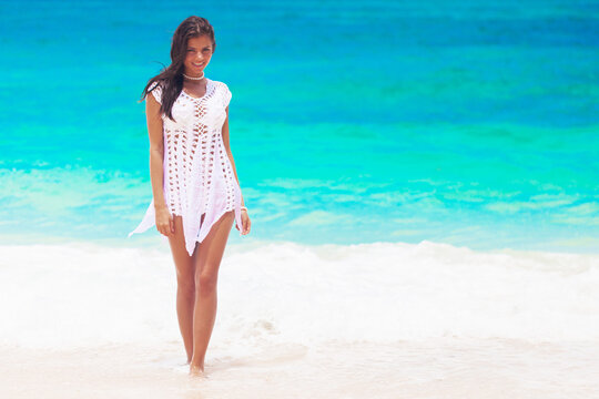 Happy woman walking on beach