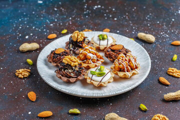 Various homemade mini tartlets with nuts and chocolate cream.