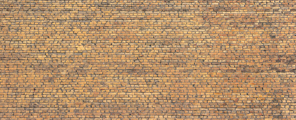 A wall of old, darkened bricks. Wide panoramic horizontal texture.