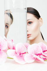 Fototapeta premium Beauty Portrait of Girl with Orchid flower
