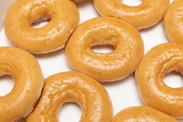 Top view Background of assorted glazed donuts in a box. Unhealthy food concept 