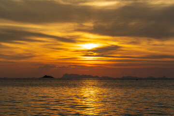 Naklejka na ściany i meble Beautiful sunset over the sea water on the island of Koh Phangan, Thailand