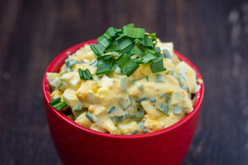 Healthy salad of green wild leek, poached egg and sour cream. Wild garlic salad with boiled eggs