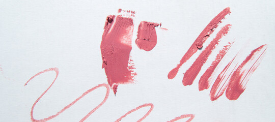 The red color of the lipstick is smeared with a zigzag stroke and lines on the white background