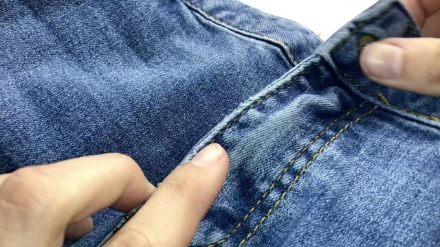 zip up zipper on blue jeans close up