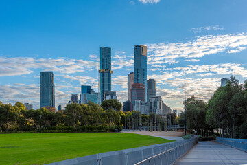 The skyline of Southbank in Melbourne, Australia with light clouds and the Federation Bells in the foreground