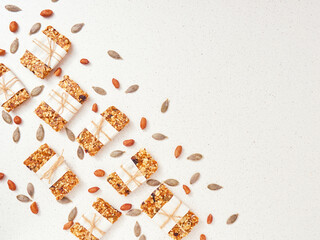 Granola bar and ingredients on a white stone table.Top view. Copy space.