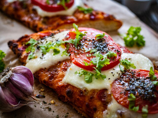Focaccia - roasted sandwiches with mozzarella and  tomatoes on wooden background
