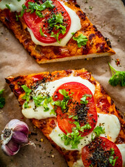 Focaccia - roasted sandwiches with mozzarella and  tomatoes on wooden background
