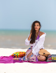 woman wearing white top posing on the beach