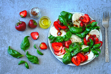 Caprese salad with strawberries. Healthy summer salad. Strawberry caprese. Diet food. Keto salad.