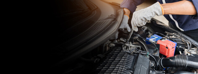 Automobile mechanic repairman hands repairing a car engine automotive workshop with a wrench, car...