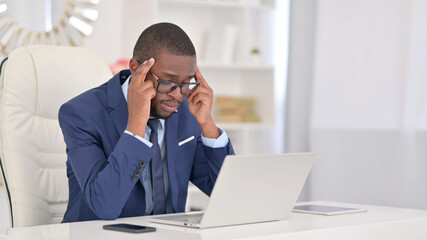 Young African Businessman with Headache at Work