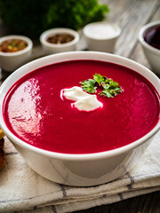 Beetroots cream soup on wooden table
