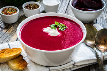 Beetroots cream soup on wooden table
