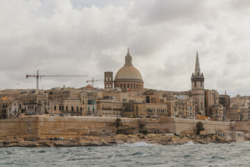 Fototapeta na wymiar Beautiful Malta capital Valleta city view on rainy cloudy day with sea