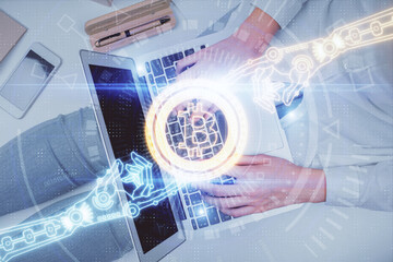 Double exposure of woman hands working on computer and blockchain theme hologram drawing. Top View. bitcoin cryptocurrency concept.