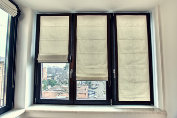 White roman curtain in white interior against the window background