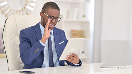 Cheerful African Businessman doing Video Call on Tablet in Office 