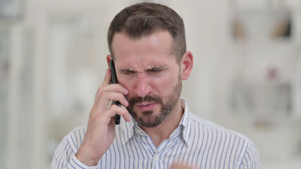 Portrait of Angry Young Man Arguing on Smartphone