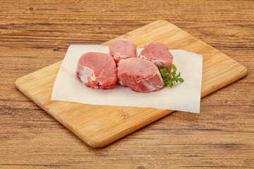 Raw pork medallion served rosemary