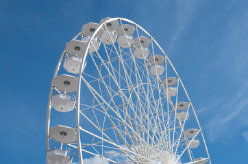 White Ferris wheel in the blue sky