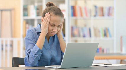 Loss, African Woman reacting to Failure on Laptop in Library