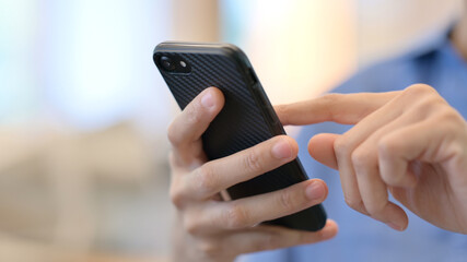 Close up of Hands of African Woman using Smartphone