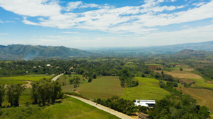 Farmland with crops and sugar cane plantations in a mountain valley. Mindanao, Philippines.