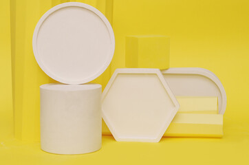 Podium in yellow color with geometric shapes. Stage with concrete, plaster geometric geometric shapes.