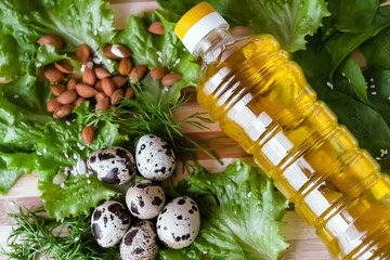 healthy food ingredients a bottle of sunflower oil nuts nuts and fresh herbs lie on the table, farm products