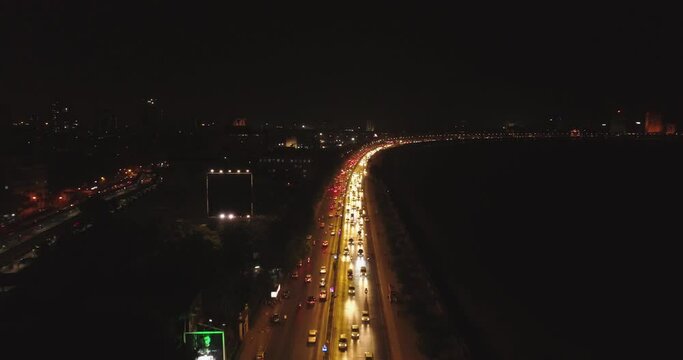 An aerial view with cinematic drone movement of the iconic Marine Drive nightlife with Air India and Trident Hotel buildings in sight.