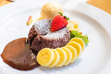A dessert dish call chocolate lava, include vanilla ice cream, banana, kiwi and apple. This sweet is made from cocoa seed. Good combination between chocolate cake, cold ice cream and fruits.