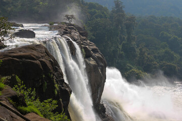 A Dramatic high angle view of one of the gorgeous waterfalls of India flows majestically down the ravines to join the river near Kochi in Kerala,India.