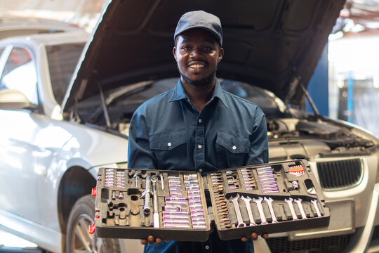 African maintenance male holding a set of car repair tools in box