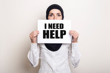 Muslim Young Woman Wearing Hijab Covers Her Face With Banner With Text I Need Help